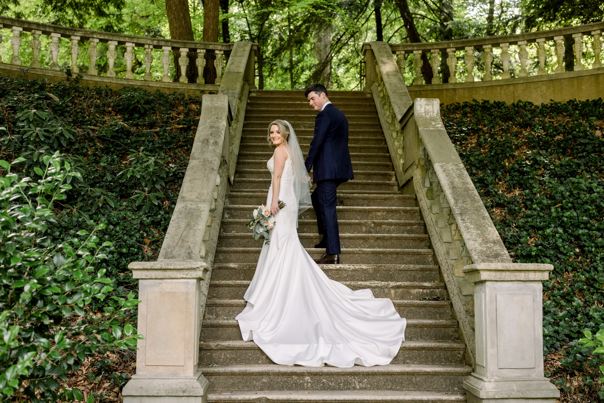bride and groom on the grand outdoor staircase at the Cator Woolford Gardens Wedding Venue