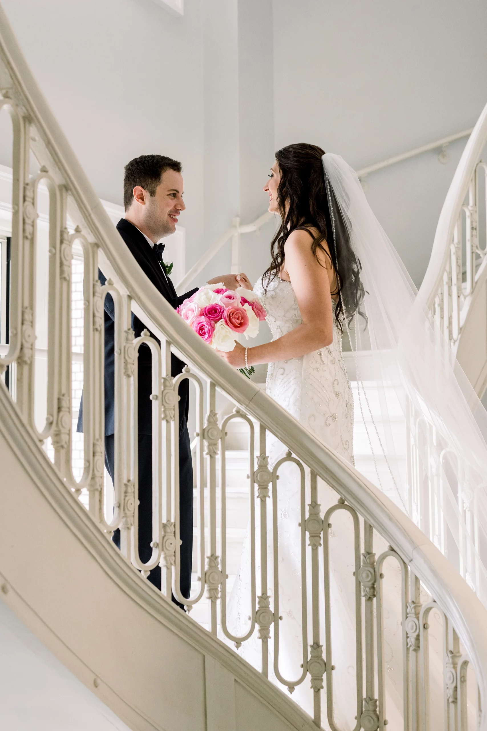 bride and groom on the staircase at their Georgian Terrace wedding