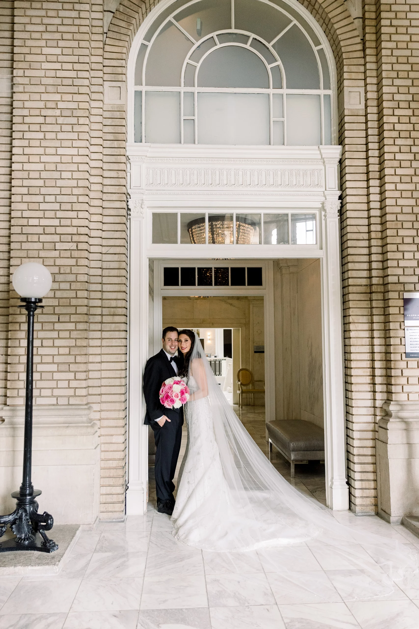 bride and groom standing in a doorway at their Georgian Terrace wedding