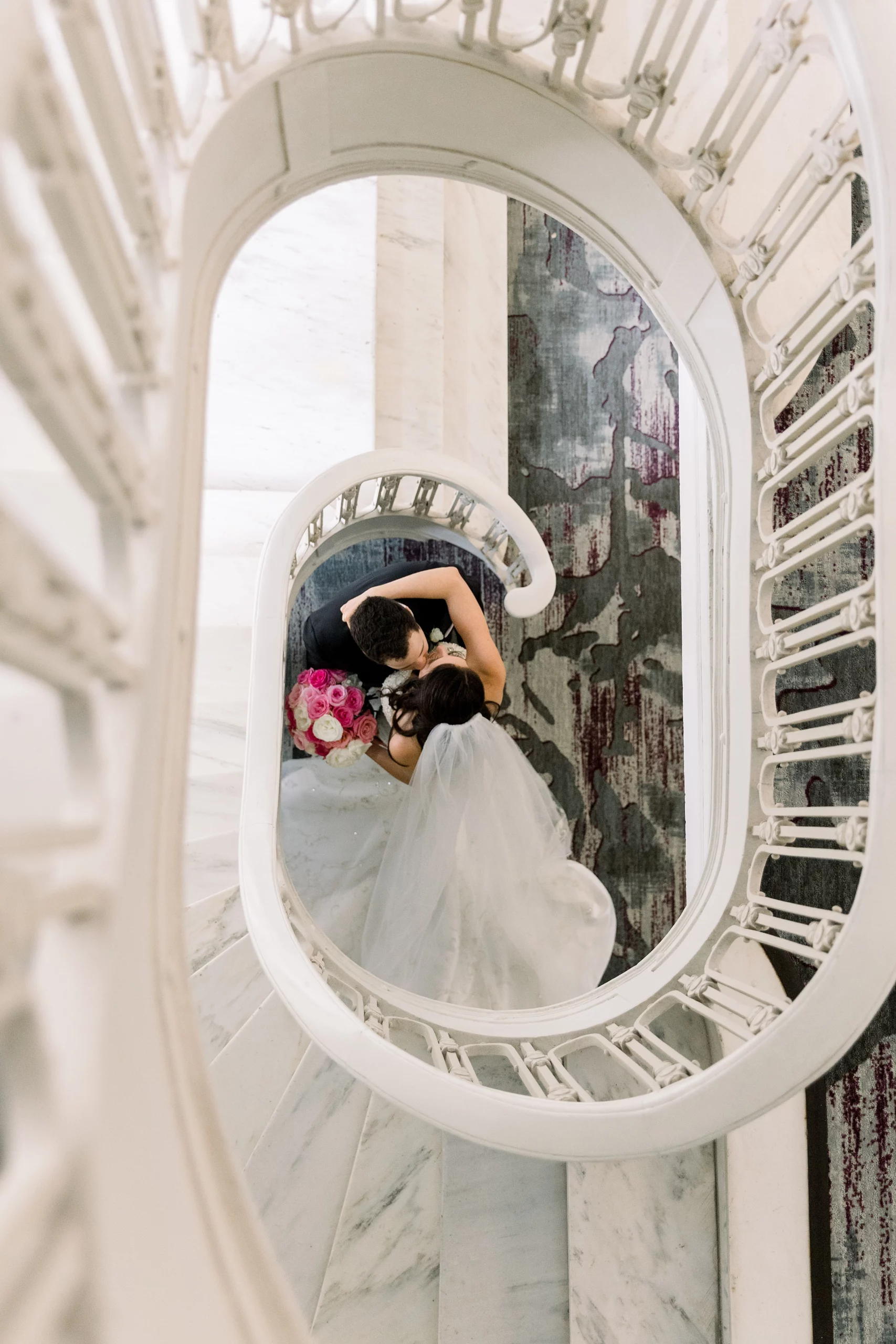 bride and groom at the bottom of a grand staircase at a Georgian Terrace wedding