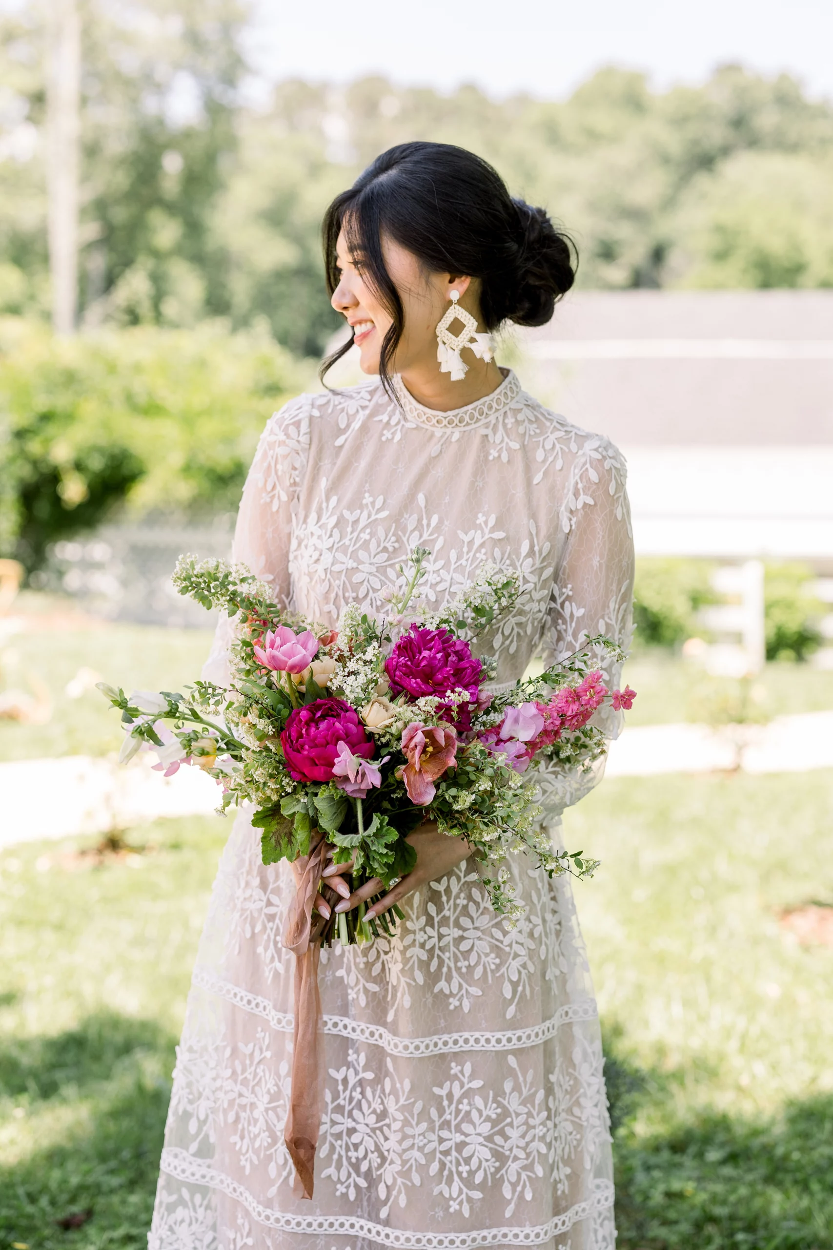 bride holding a bouquet of pink flowers at The Wildflower Barn wedding