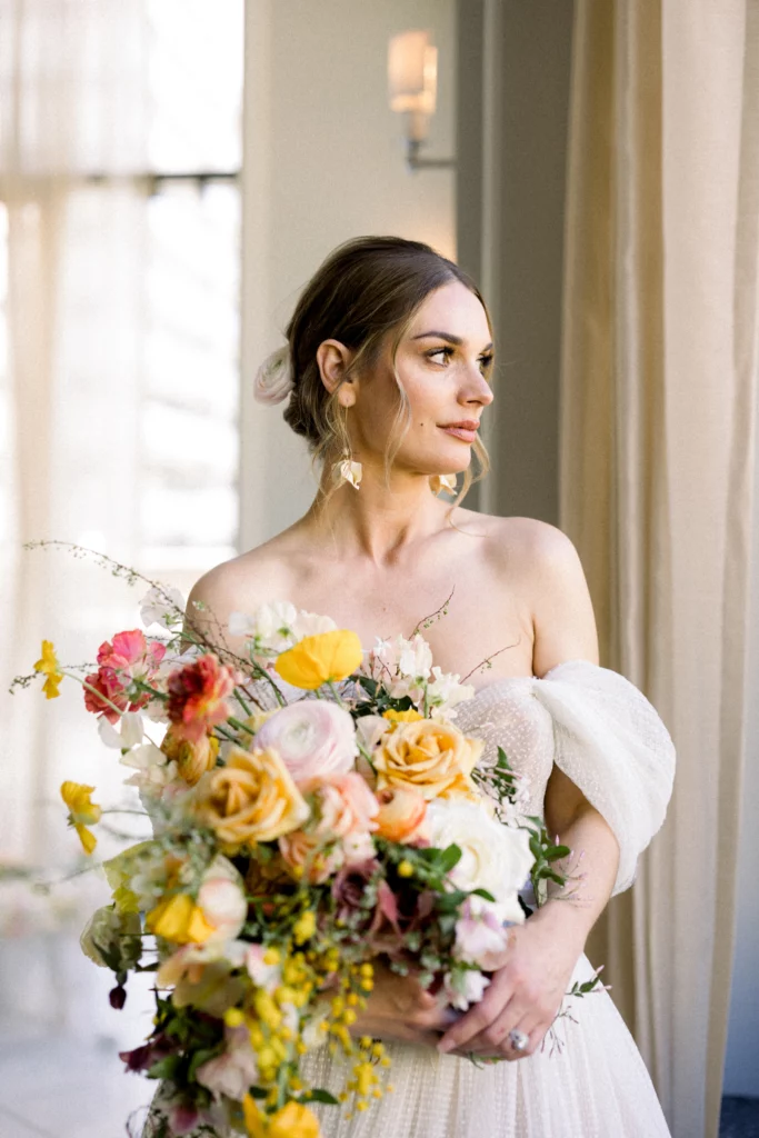 bride holding a bouquet of colorful flowers at the Waldorf Astoria Atlanta Wedding venue