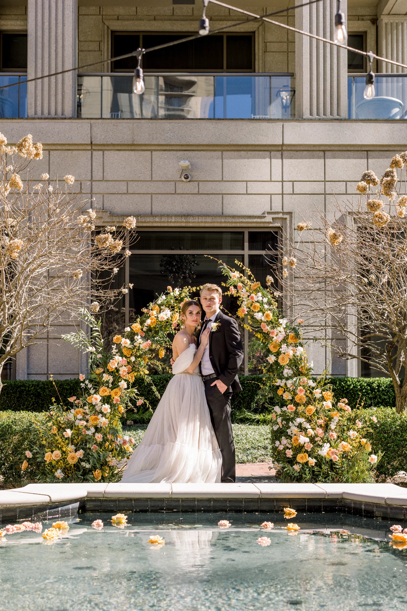 bride and groom standing under a flower arch at the Callanwolde Fine Arts Center Wedding venue