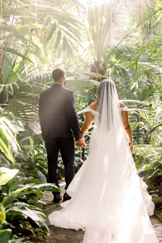 bride and groom standing in a garden