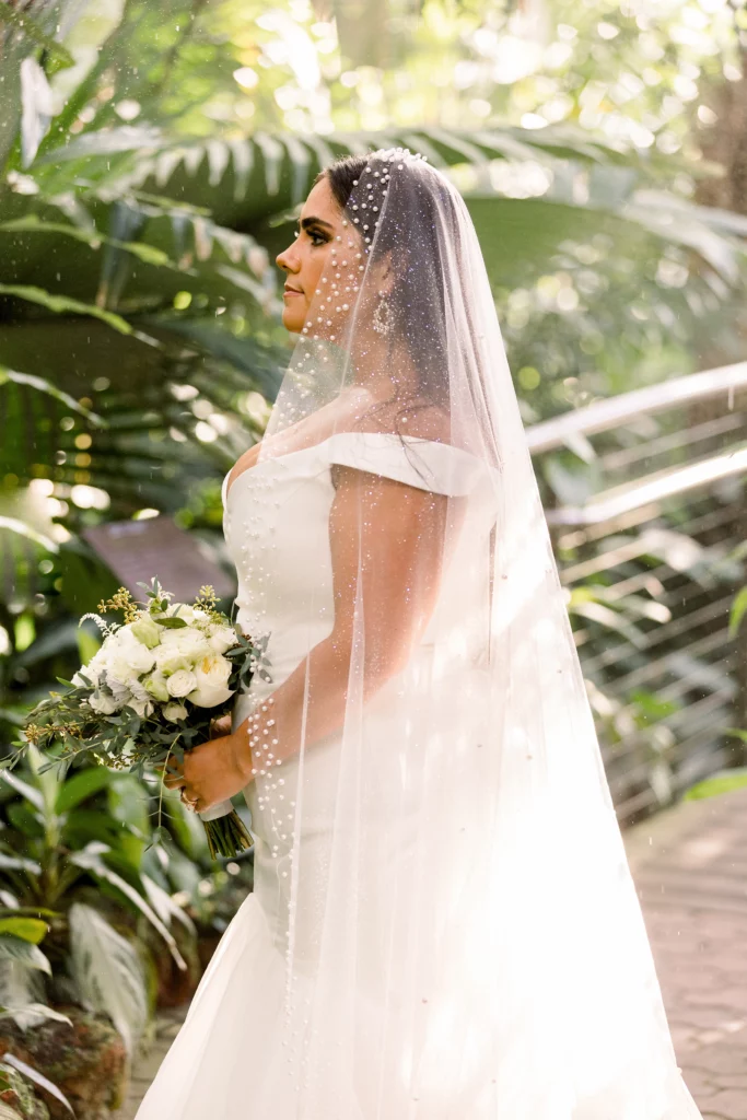profile of a bride standing in greenery at an Atlanta botanical gardens wedding