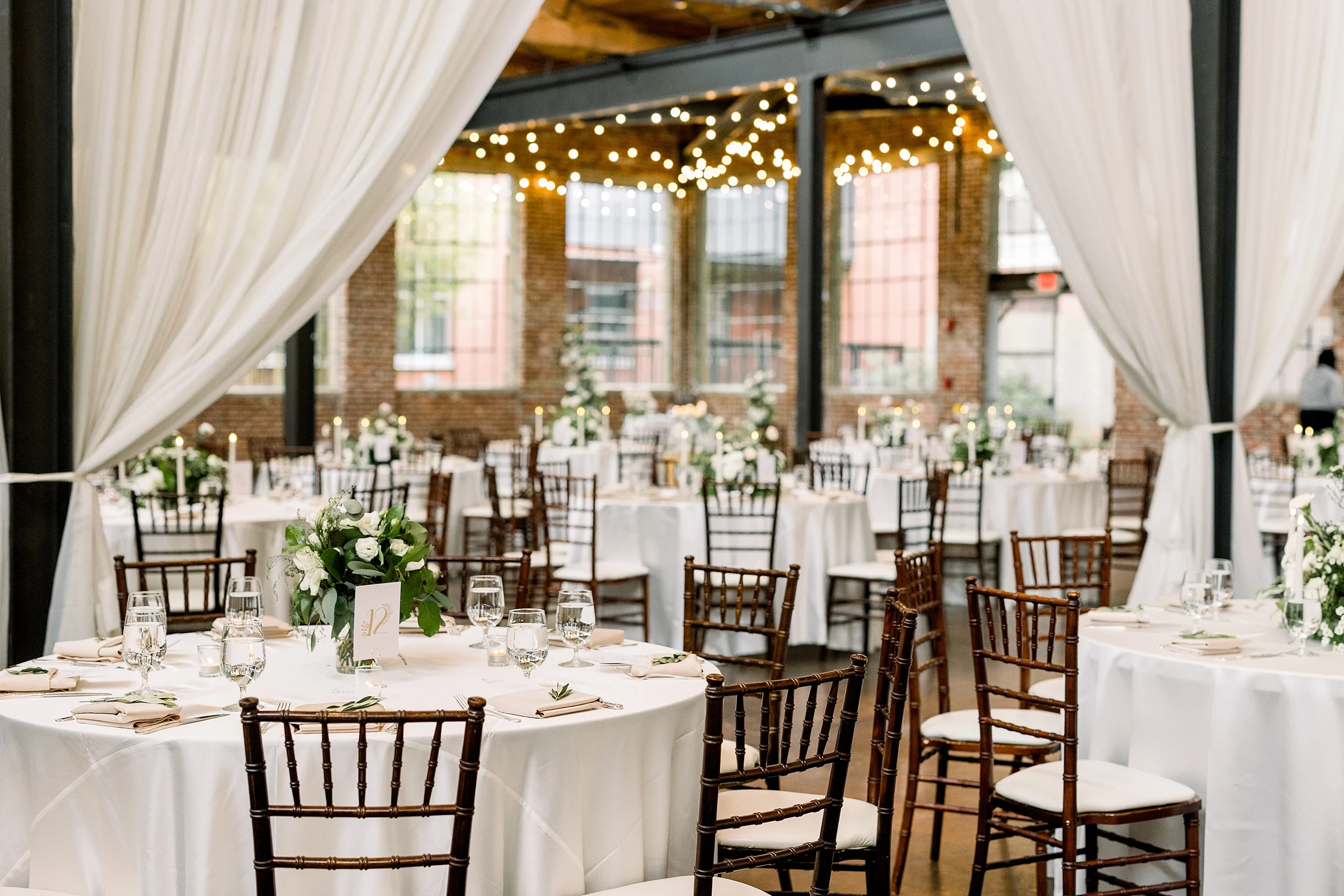 String lights over the reception at the foundry at puritan mill wedding