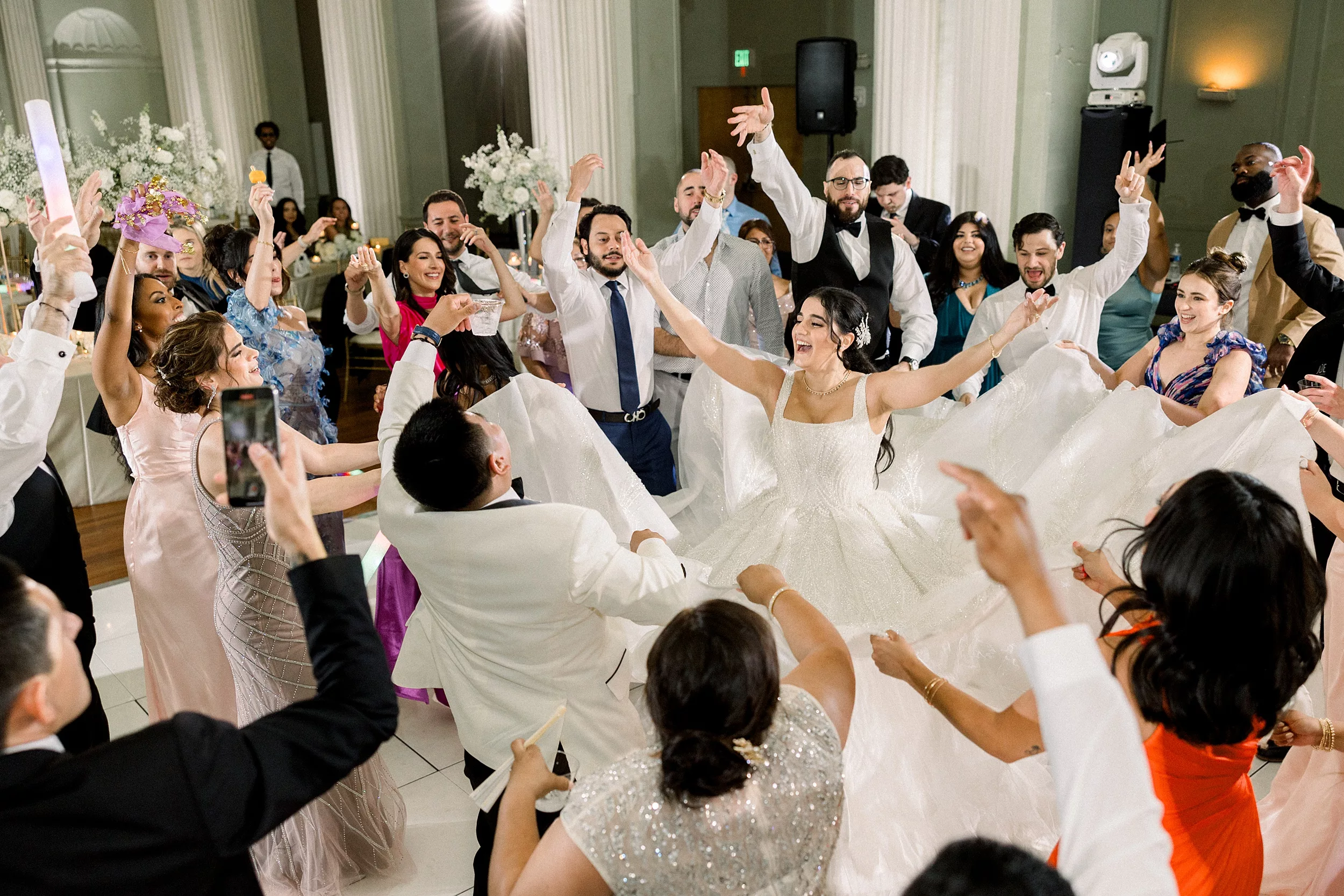 Newlyweds celebrate and dance in the middle of the dance floor at their Biltmore Ballrooms Wedding