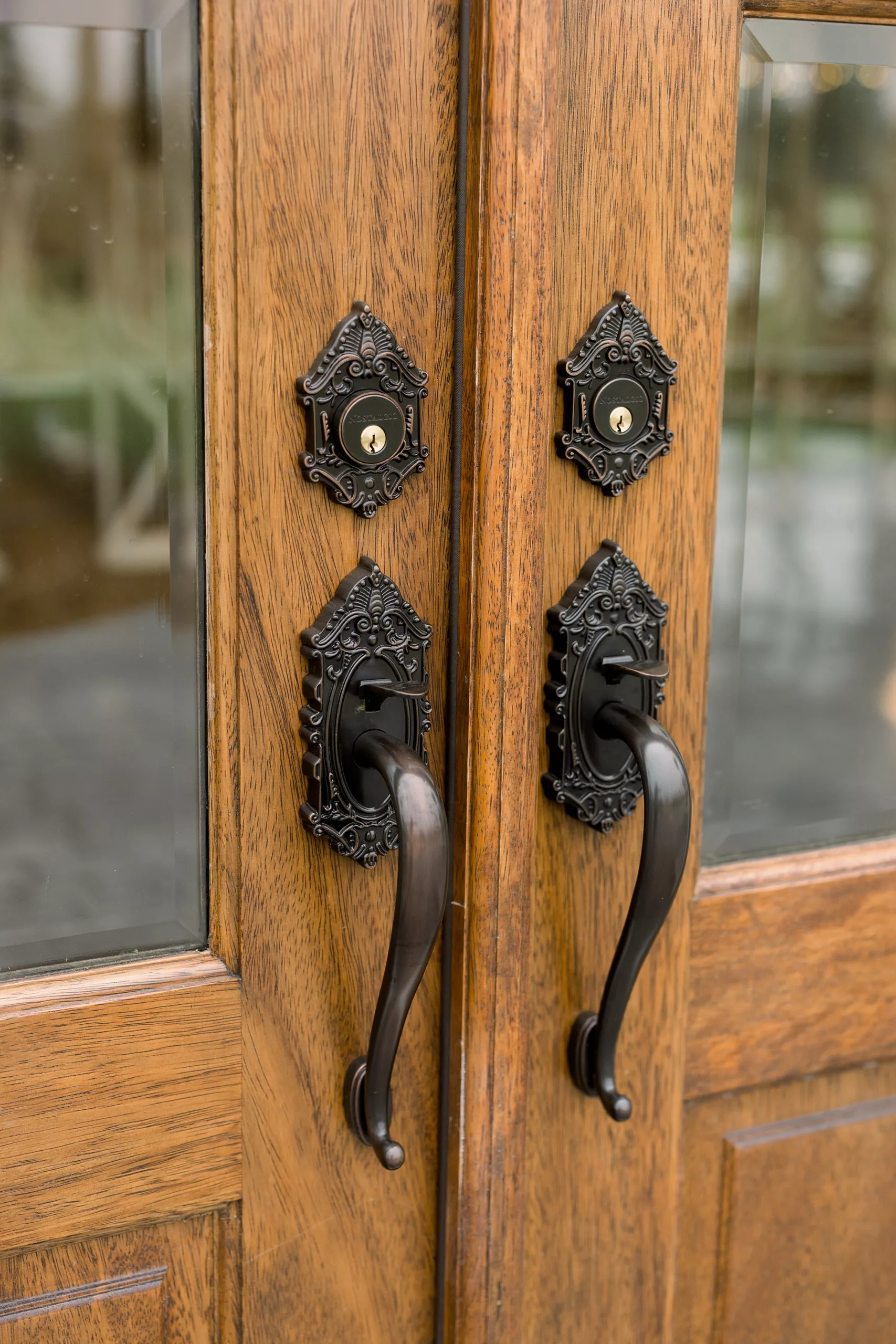 Details of ornate handles and locks on natural wood doors