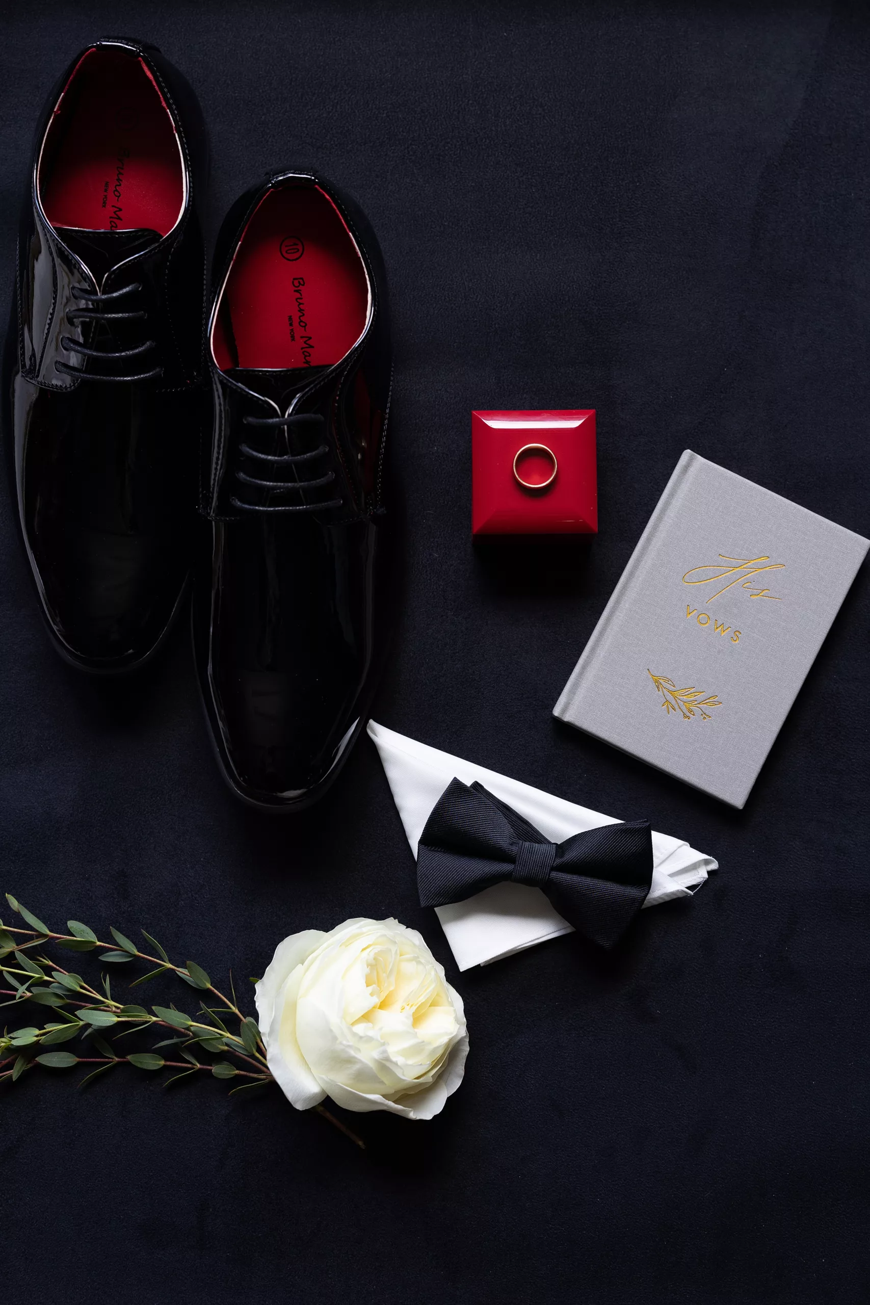 Details of a groom's shoes and wedding details