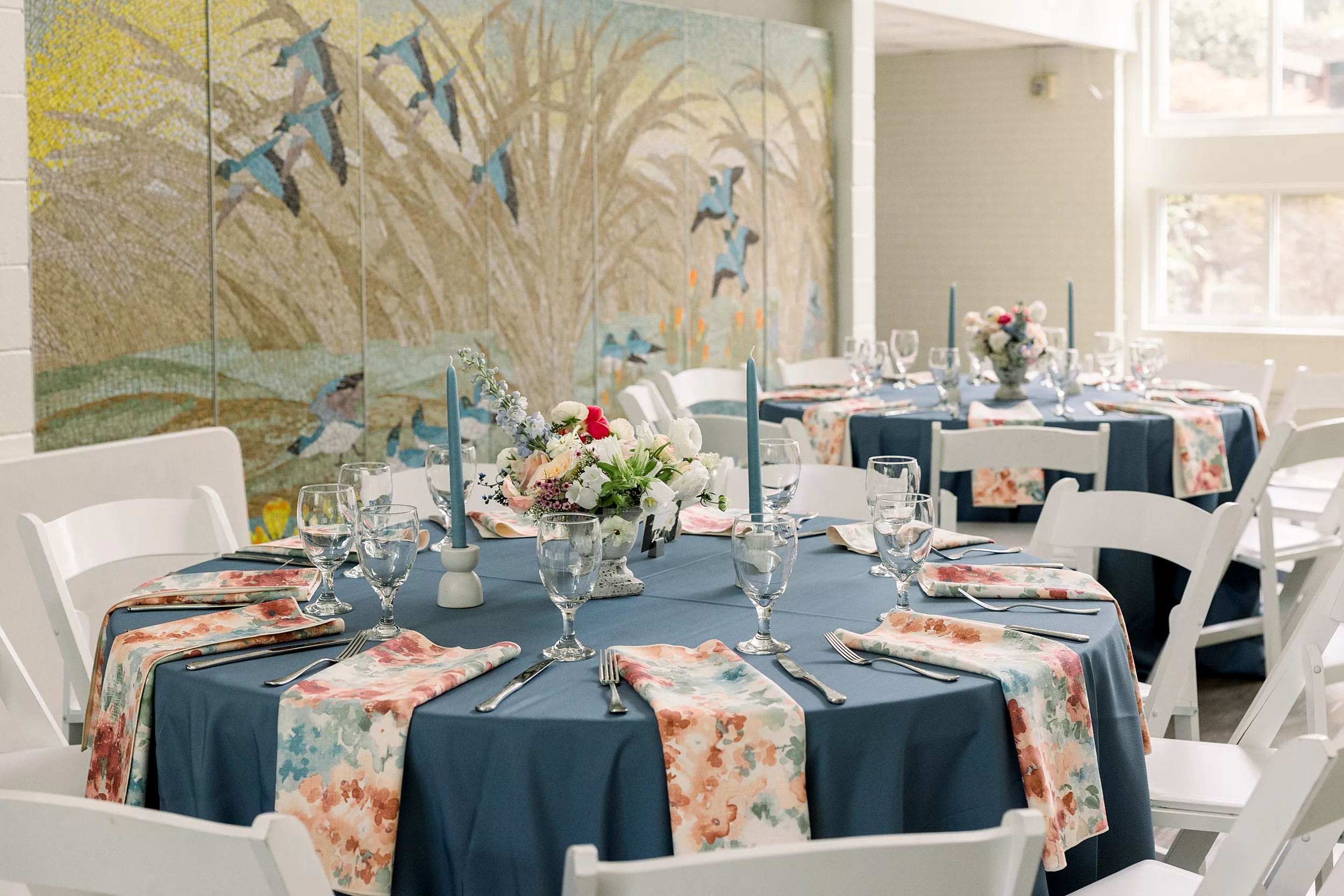 Details of a wedding reception table with a floral centerpiece