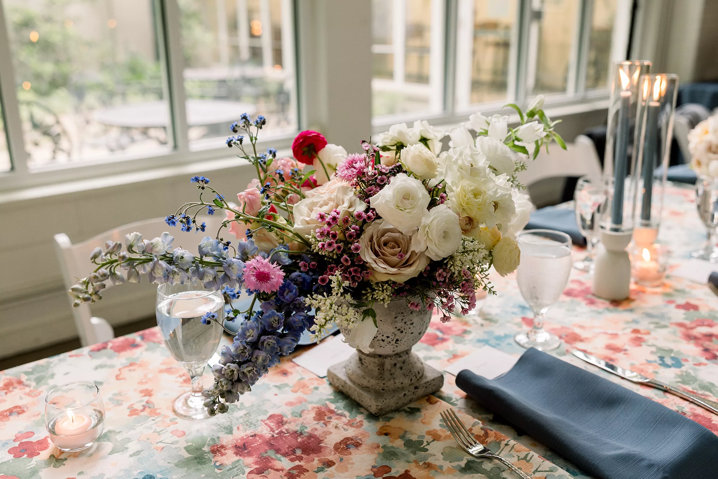 Details of a colorful table setting for a wedding reception with floral print linens and colorful flowers at a Cator Woolford Gardens Elopement