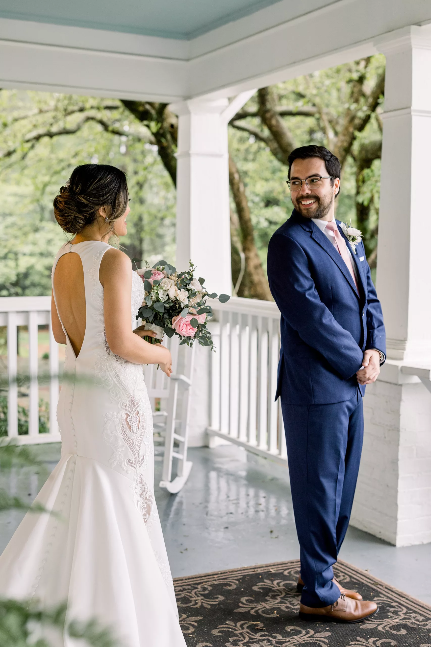 A groom turns around to see his bride in her dress for the first time during a first look wedding