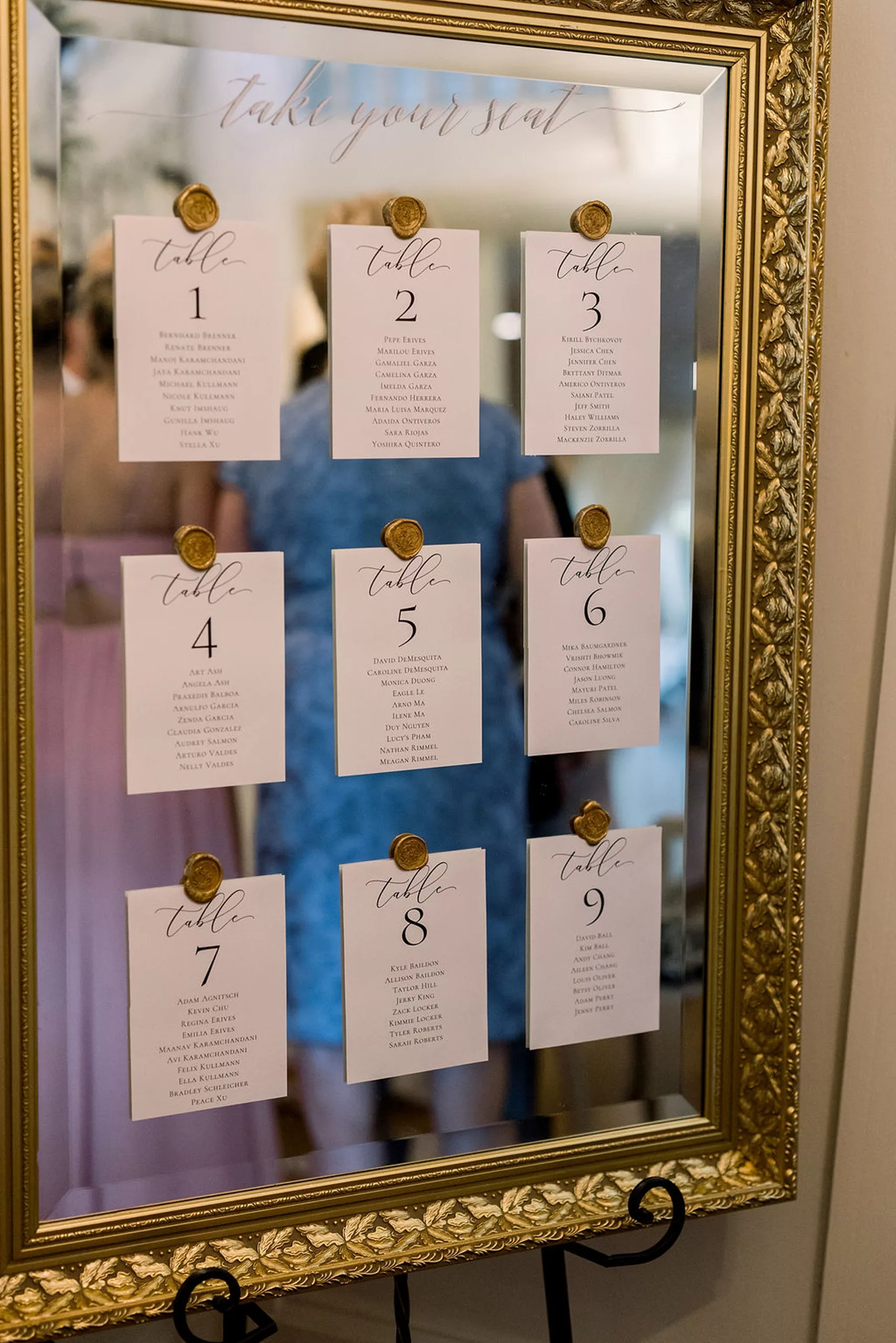 Details of a mirror with table assignments wax-stamped onto it at a payne-corley house wedding