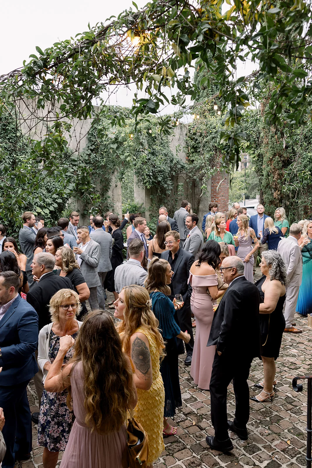 An overhead view of a a wedding cocktail hour on a brick patio at the Summerour Studio Wedding venue
