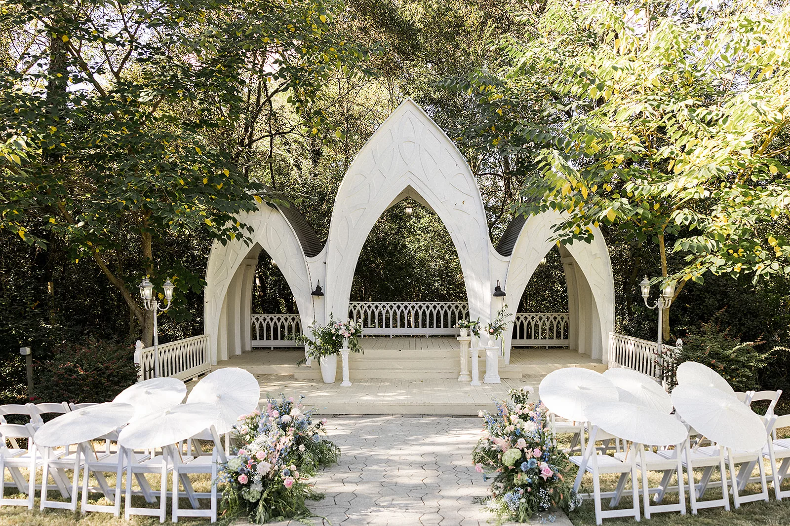 A Wildflower 301 wedding ceremony with white chairs and colorful florals