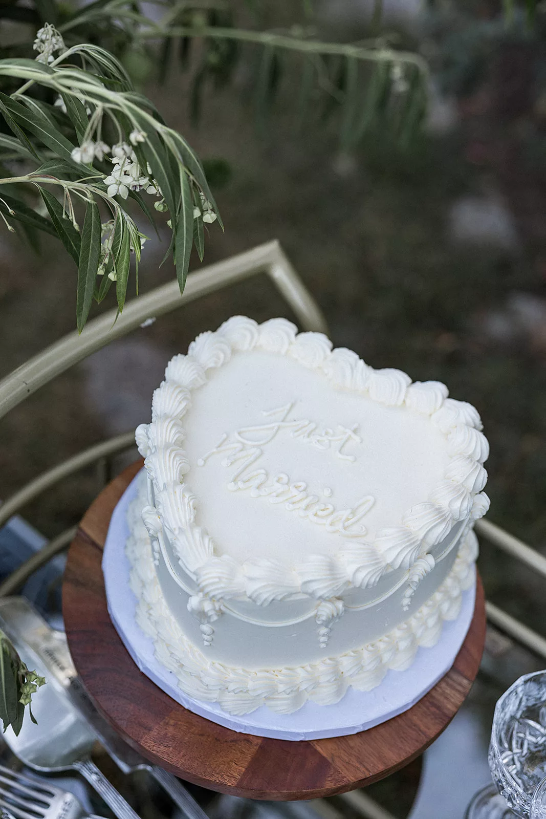 Details of a small wedding cake sitting on a cart outdoors