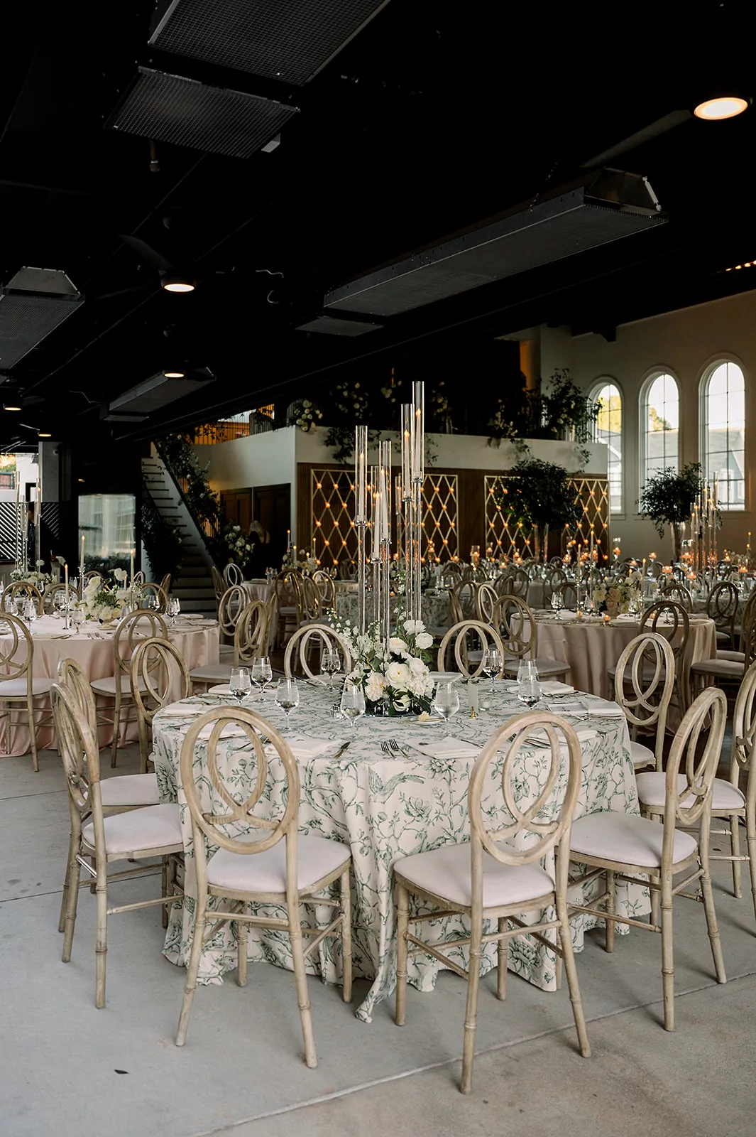 Details of an indoor wedding reception set up with floral linens