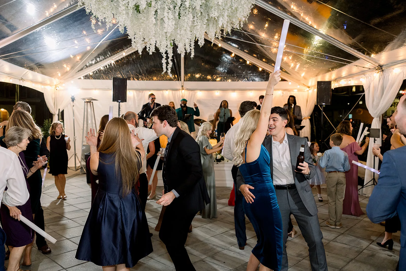 A wedding reception dances to a live band in a tent at The Chapel Athens