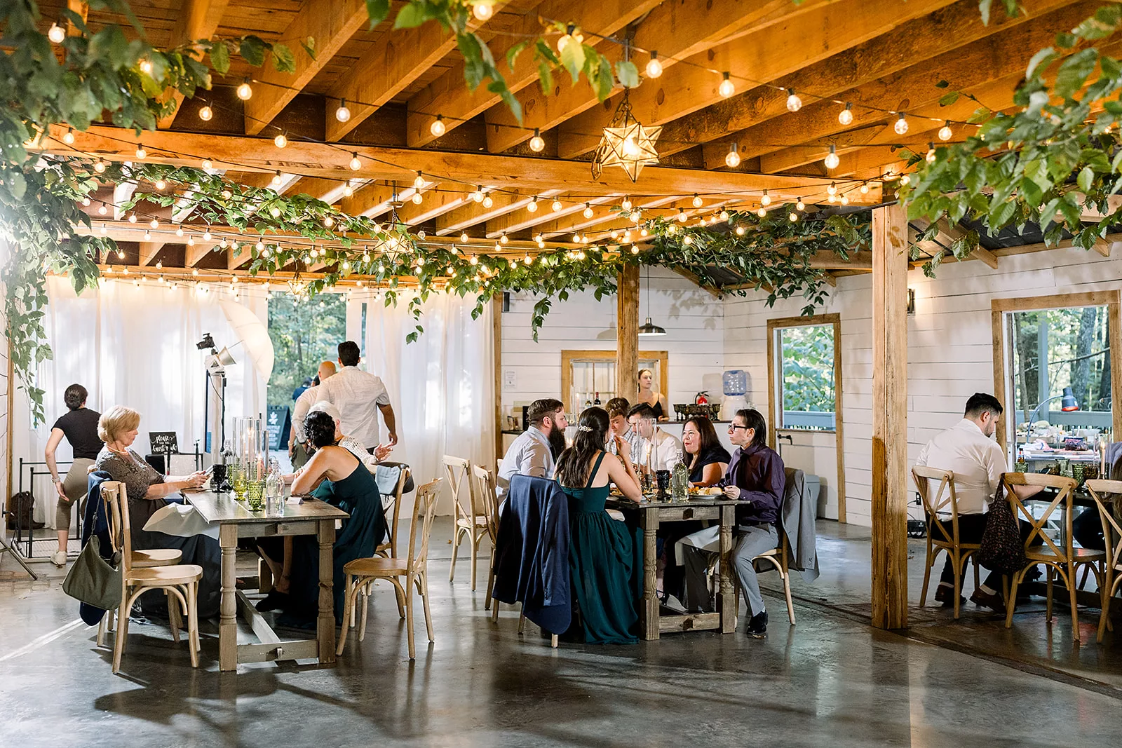 A group of wedding guests eat outdoors at a Sustainable Wedding Venue