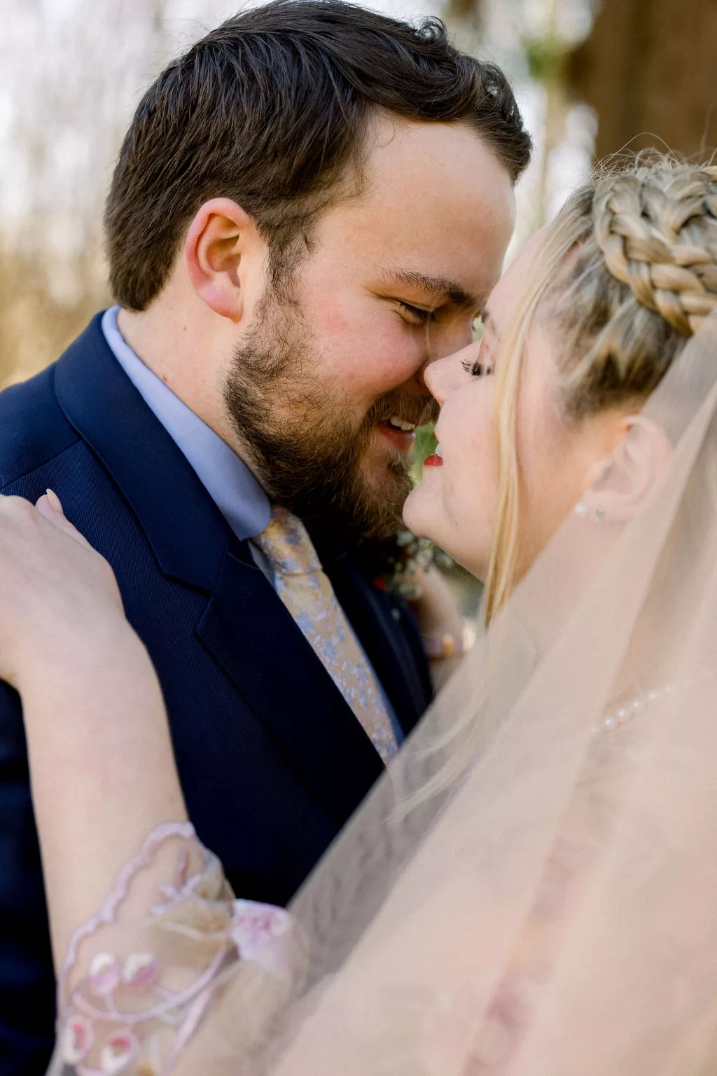 Newlyweds lean in for a kiss while smiling