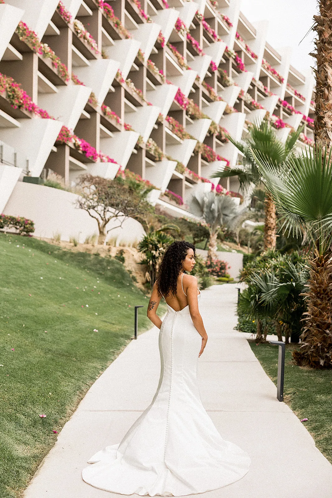 A bride walks along a sidewalk at the Grand Velas Los Cabos Wedding venue