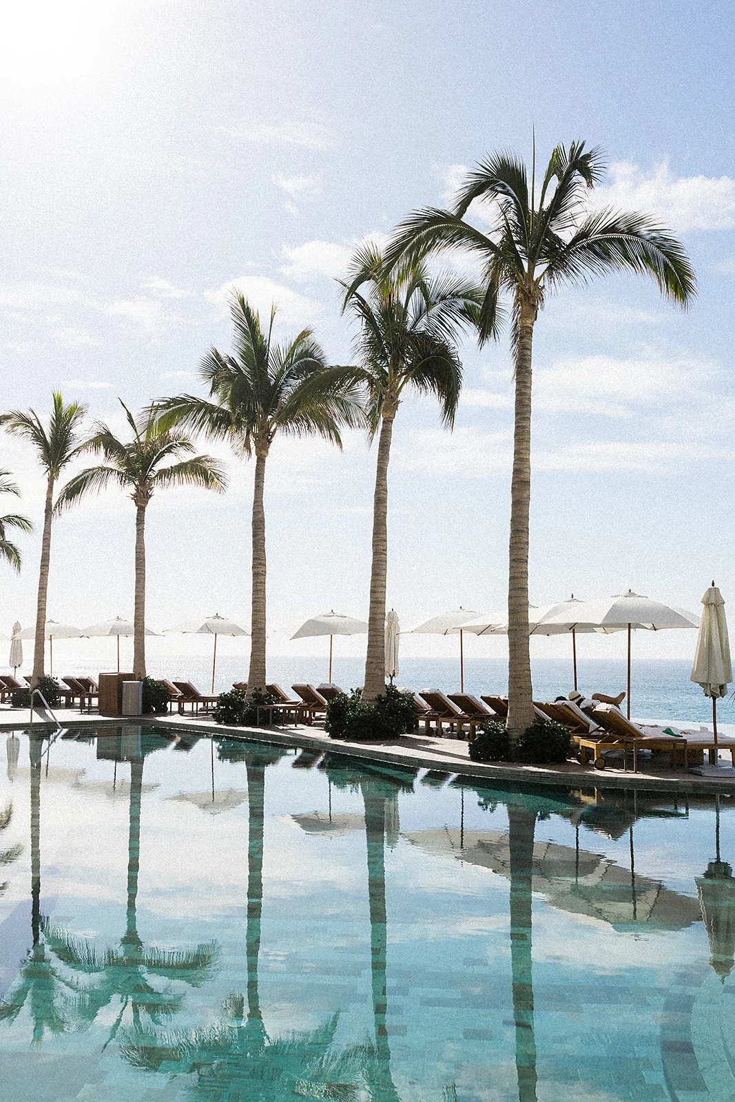 A peek at the pool and chairs along the beach view at the Grand Velas Los Cabos Wedding venue