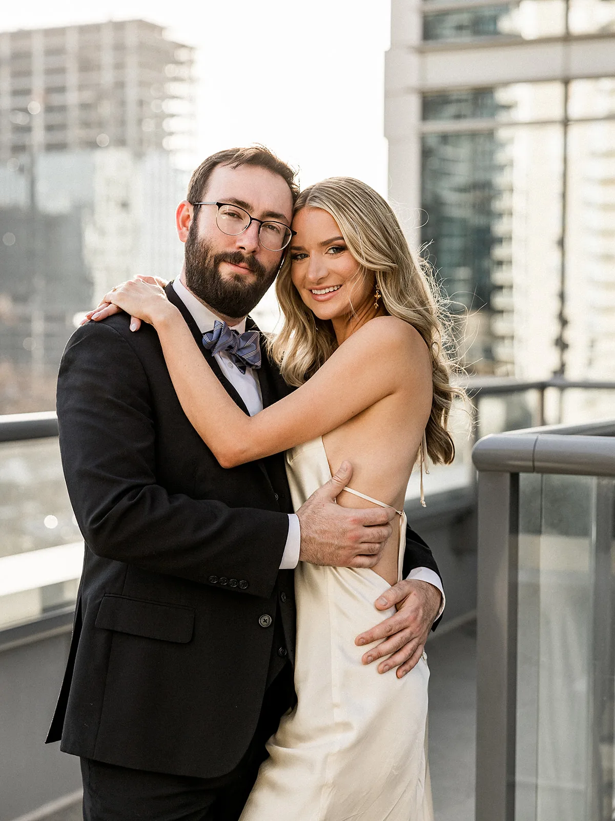 Newlyweds embrace and smile during their wedding on a terrace at Epicurian Atlanta